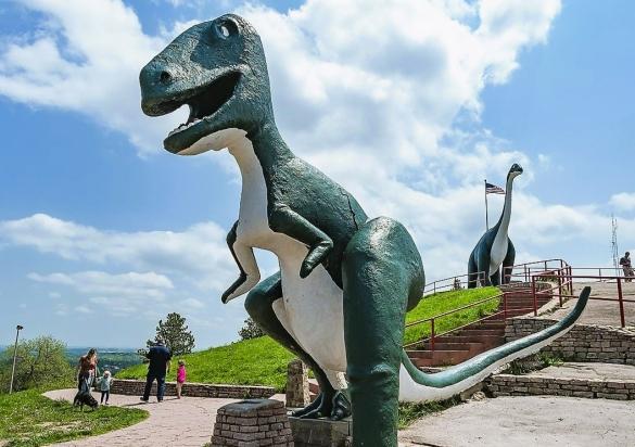 A dinosaur state stands above visitors at Dinosaur Park in Rapid City